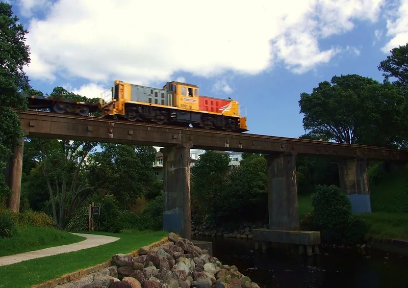 Te Henui stream and walking path beneath a railway bridge